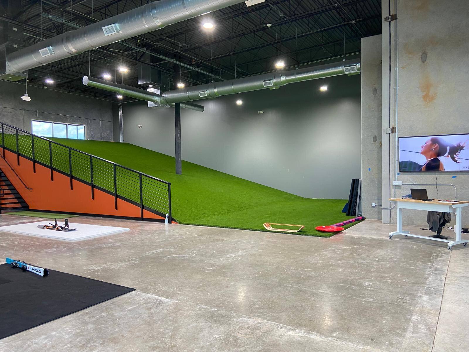 Indoor ski slope and training floor built inside a bare shell by NorthStar Commercial Interiors in Plano, TX