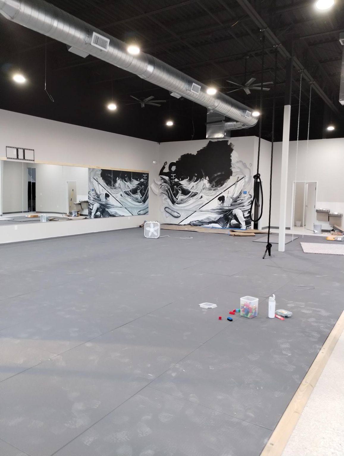 The training floor matted and the mural complete, before the wall pads and equipment went in, at Kung Fu Academy of North Texas in McKinney, TX