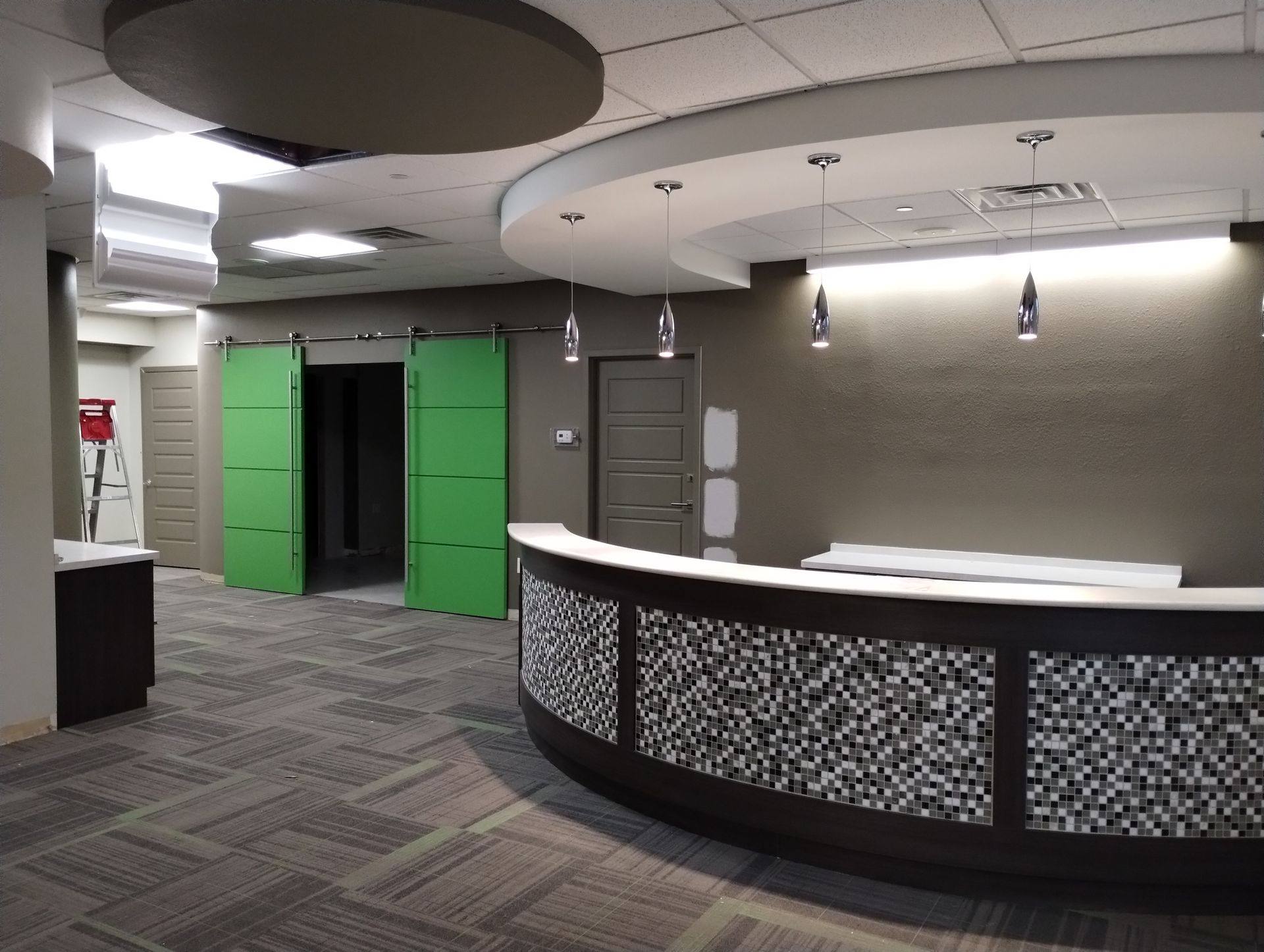 Before: the dark reception area at Building Bridges Through Communication in Frisco, TX
