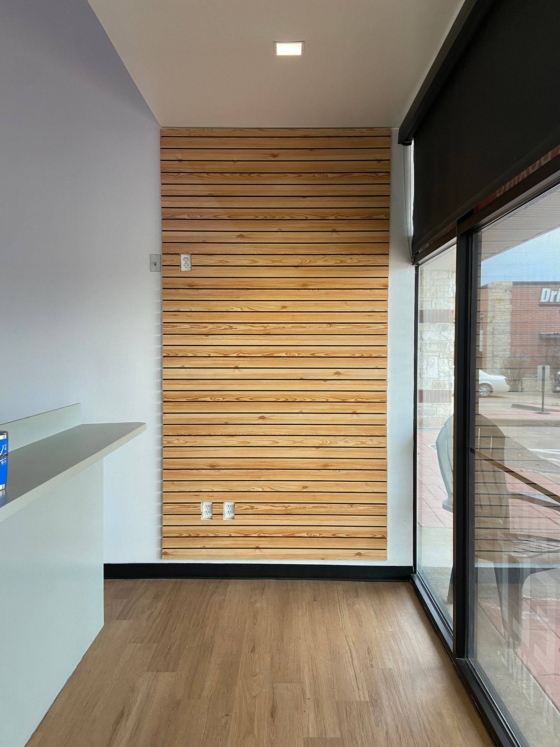 After: the finished slat-wall retail area at Professional Black Belt Academy in Prosper, TX