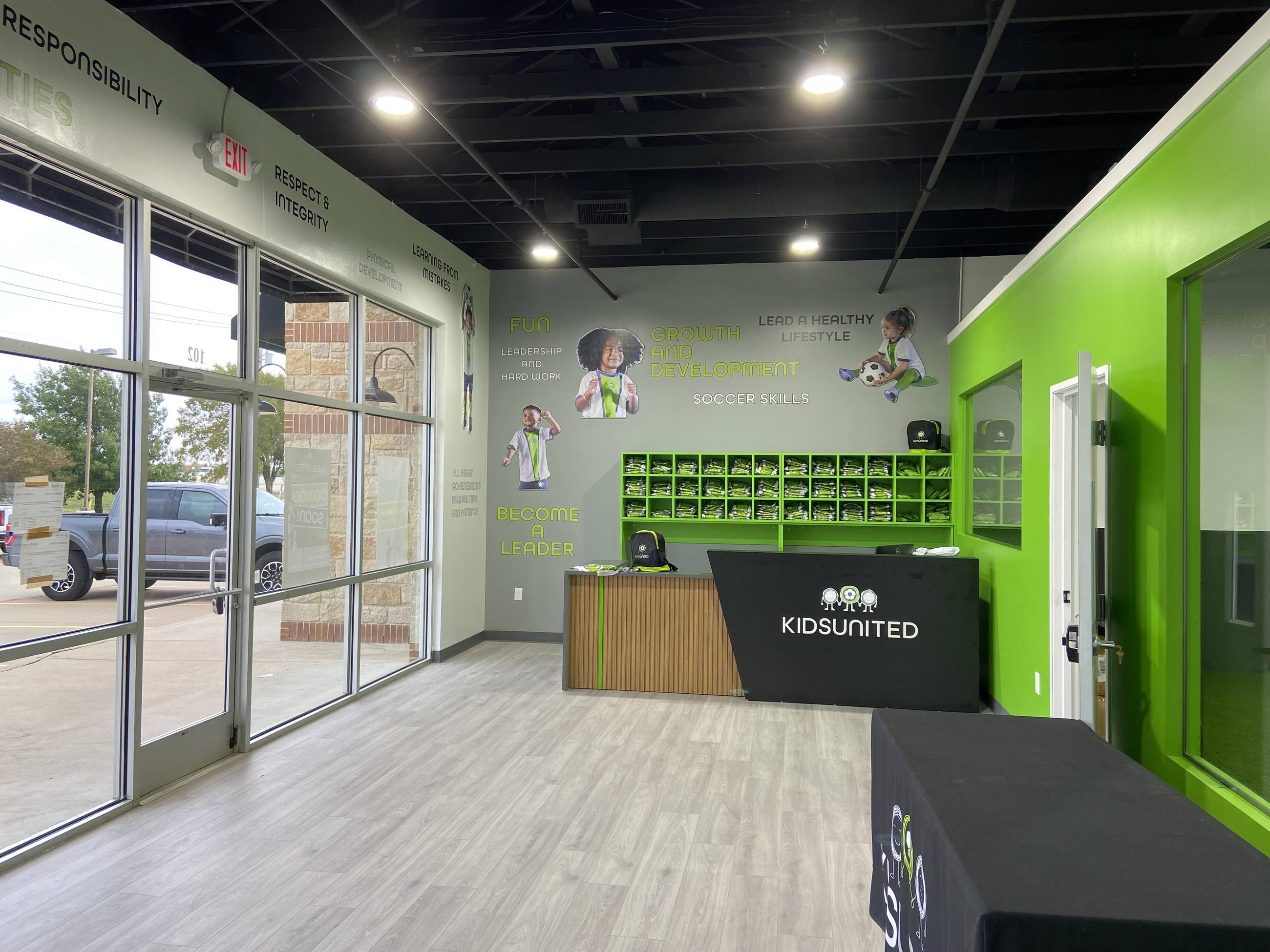Completed reception desk and turf training area at Kids United in Plano, TX