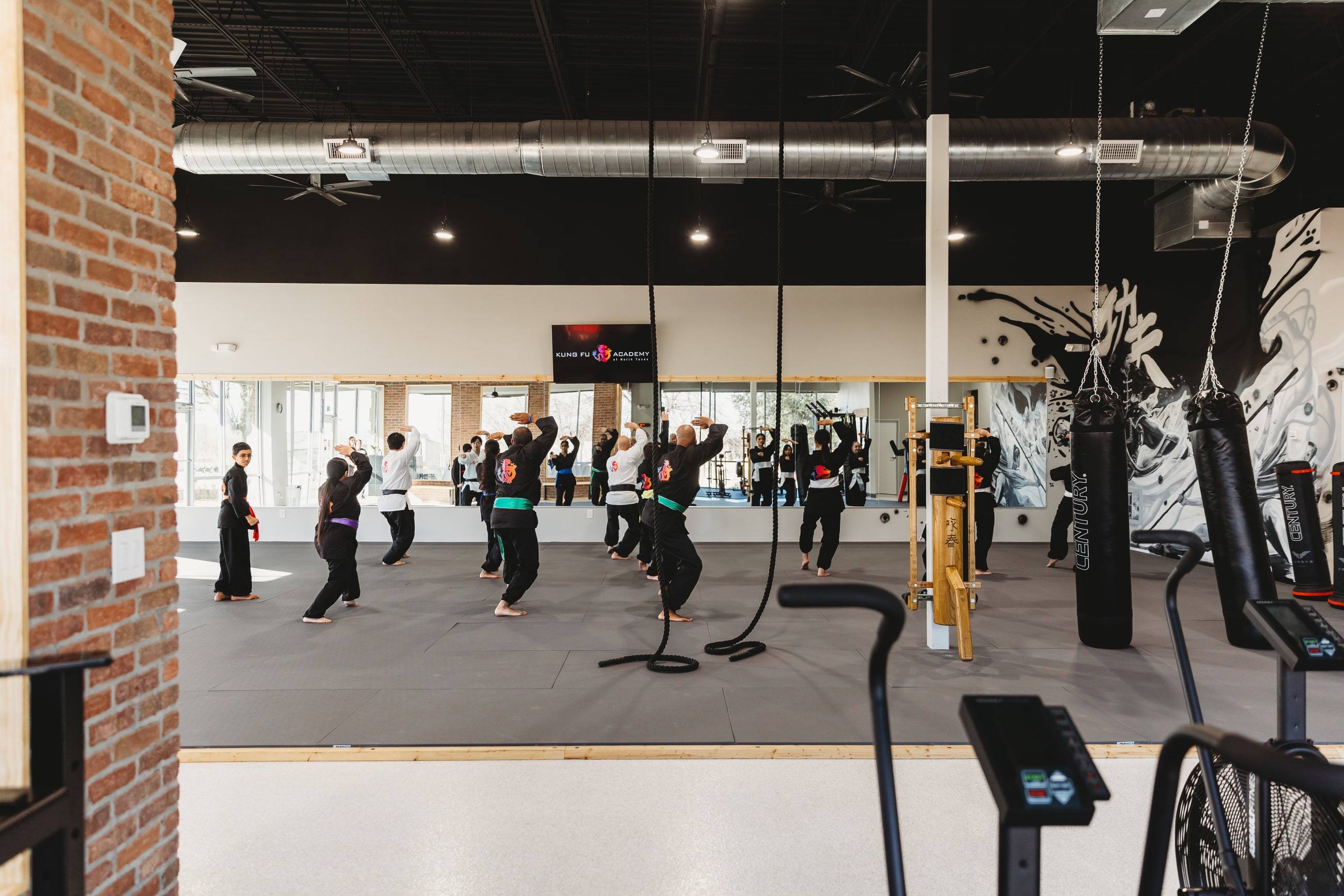 Spectator area and epoxy floor looking onto the training mat at Kung Fu Academy of North Texas in McKinney, TX